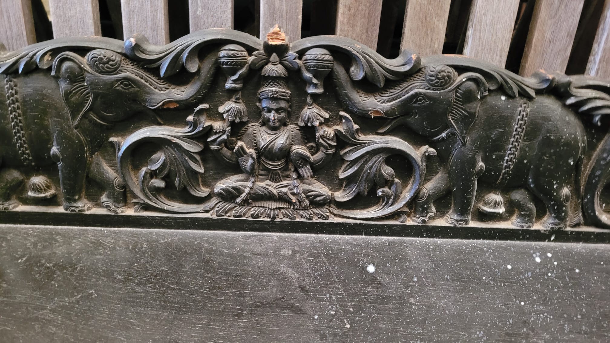 An Indian carved ebonised oak bracket, length 152cm, depth 36cm, height 21cm